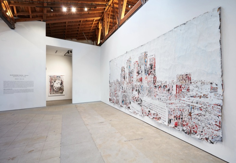 Gallery installation with carved cityscape mural — Annihilation, Los Angeles