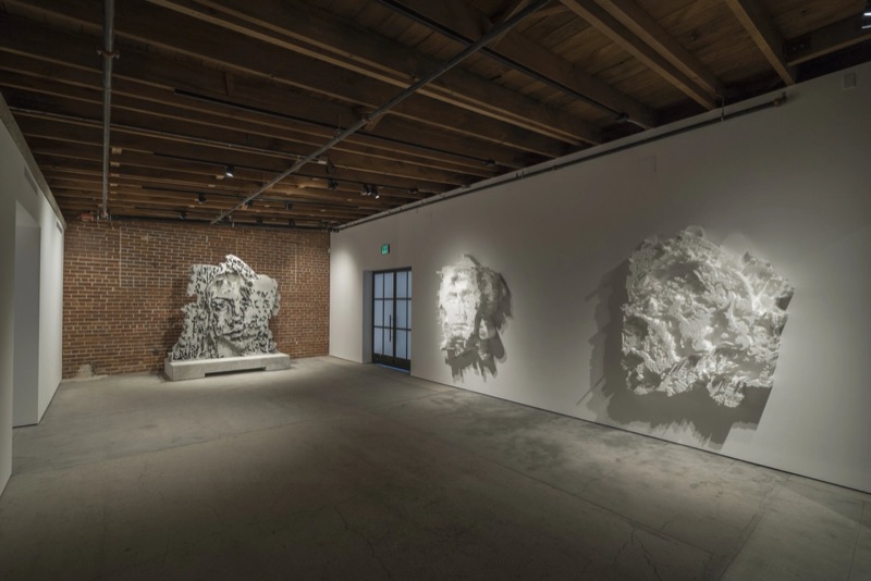 Three works on the brick gallery wall at Annihilation, Los Angeles