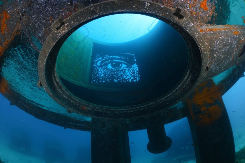 EDP Art Reef — carved eye seen through a porthole of the submerged structure, off Albufeira