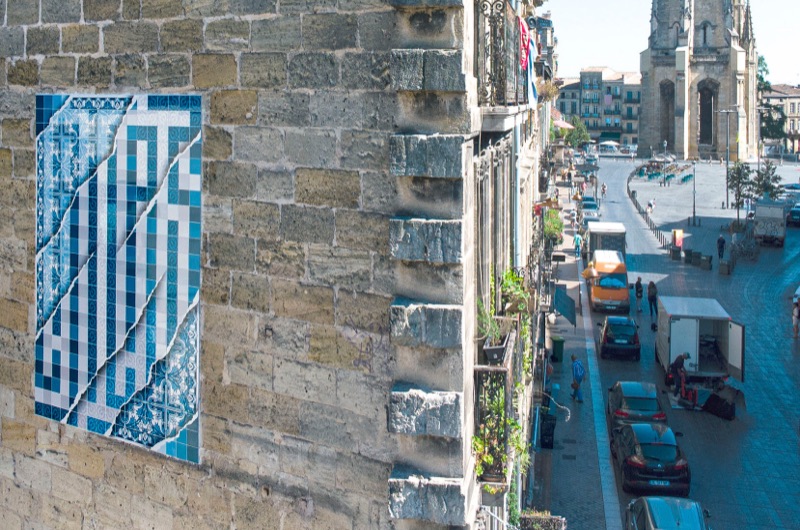 (No) Borders — Add Fuel azulejo intervention on stone facade, Porto