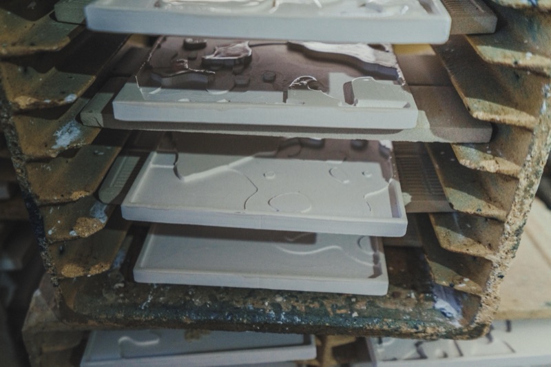 Relief tiles drying in the kiln racks