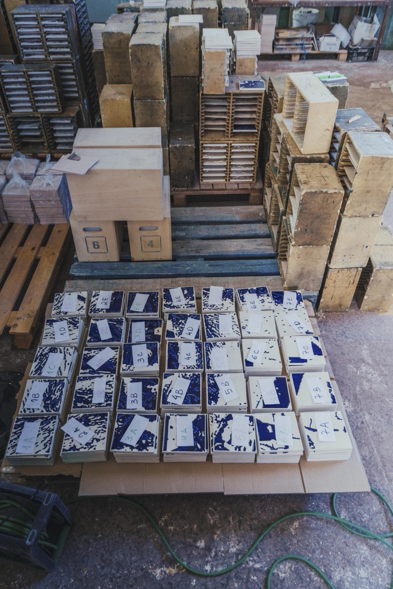 The Rasura edition on pallets amid the tile-factory racks