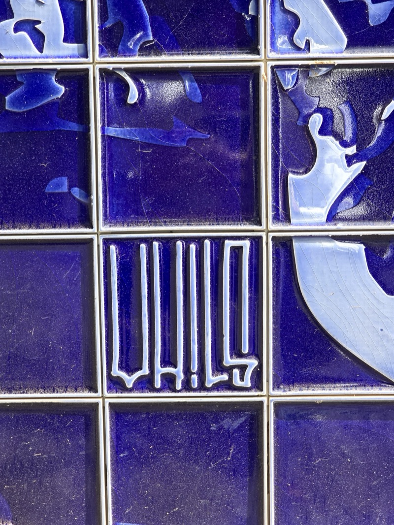 Carved VHILS signature in the cobalt-glaze tiles at Monte Palace