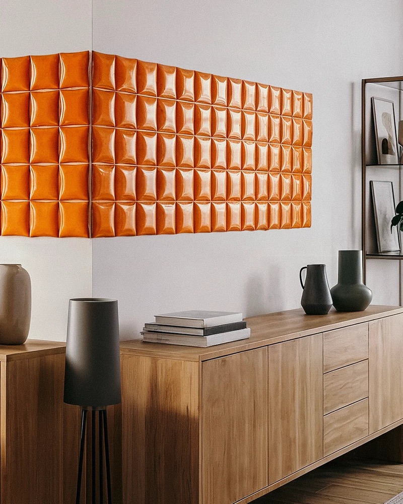 Catalogue render — orange relief tiles in a living-room interior above a wooden sideboard