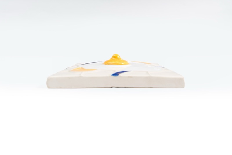 ana+betânia relief tile with yellow glaze accent, edge-on product view