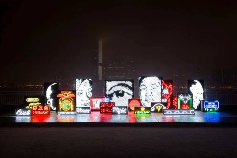 Carved neon installation on the Hong Kong waterfront at night — Debris