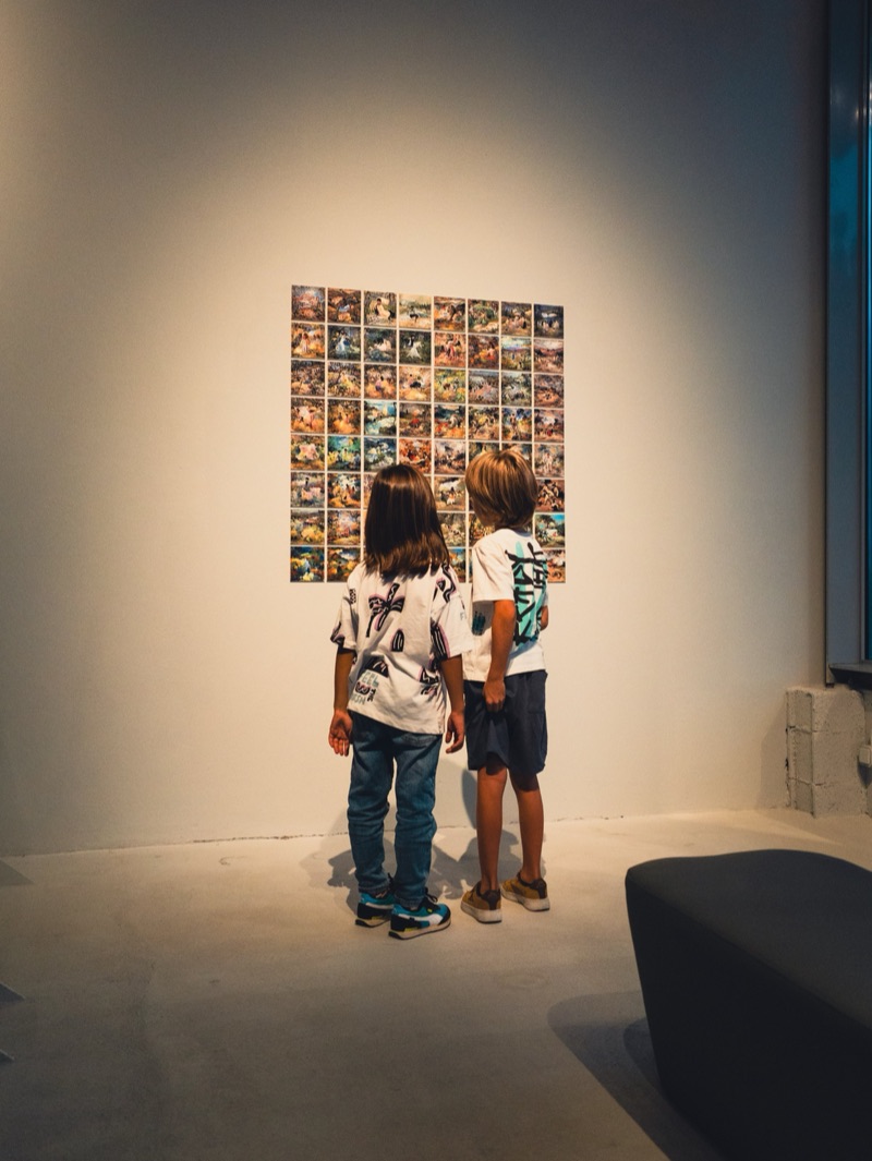 Young visitors before Botto's discarded-fragments grid