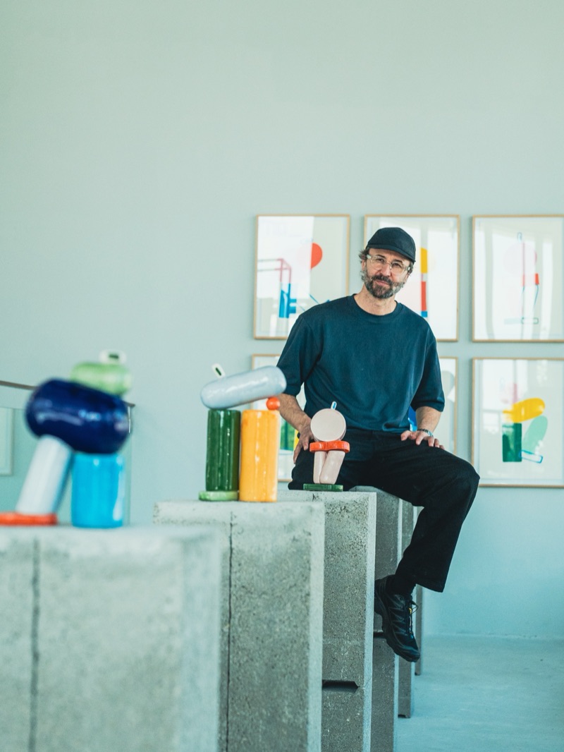 Lucas Zanotto with ceramic sculptures and framed prints