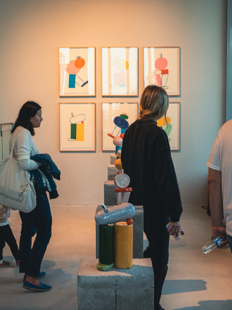 Visitors with the PLAY+REPEAT print grid and sculpture stacks