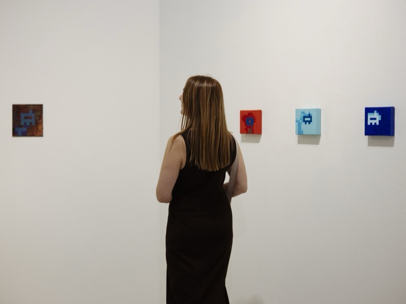 Unpermissioned Self: Proof of Being — visitor with the glass and wall works, Eterno Gallery