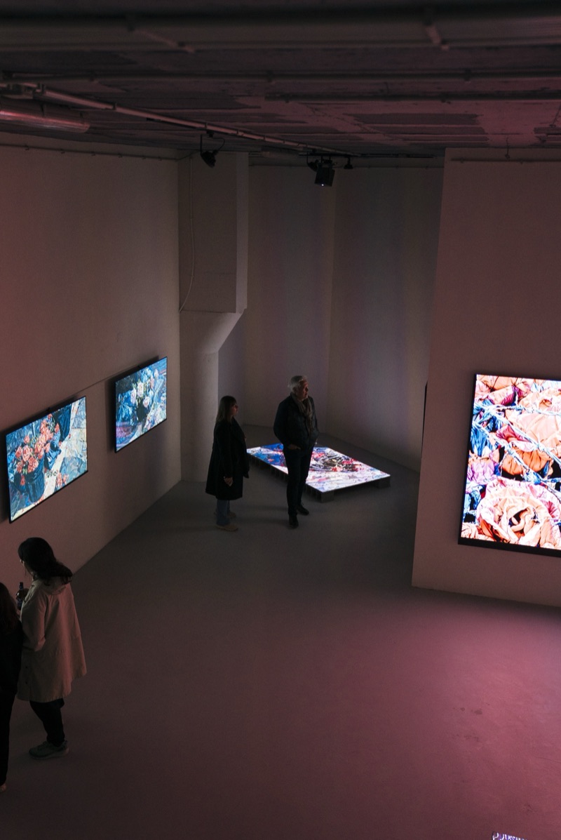 Wrong Side of the Fence by 0009 (Chris Maestas) — elevated view of the basement gallery with visitors at the opening