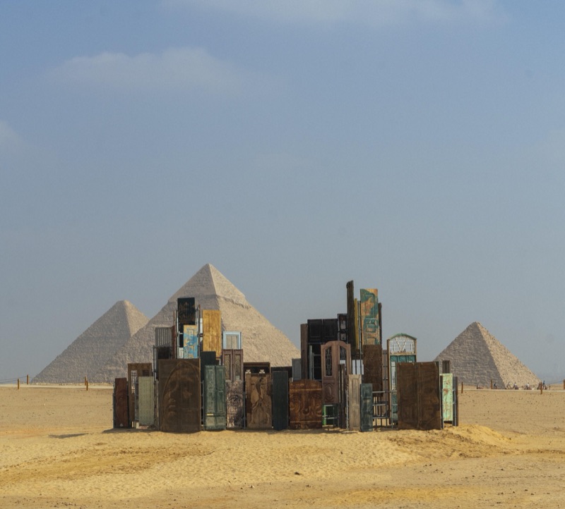 Doors of Cairo standing beside the three pyramids at Giza