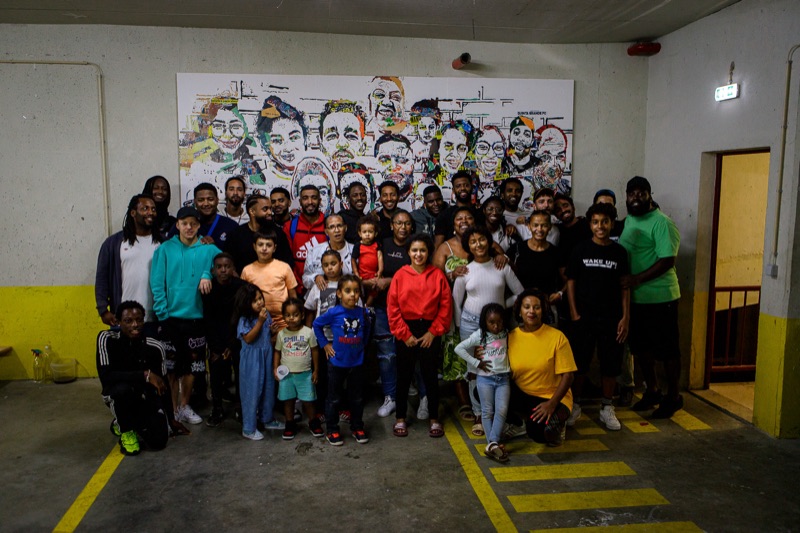 PER 7 (Quinta Grande) residents with the finished Vhils community mural — 31 residents' faces