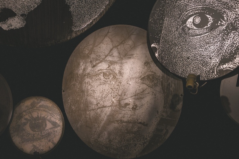 Carved discs in the dark installation room at MIMA