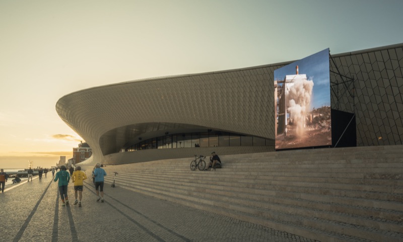 The MAAT wave-facade screen at sunset — Prisma