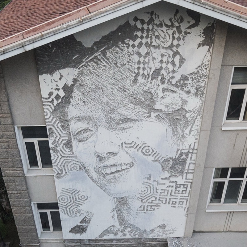 Vhils carved-facade portrait