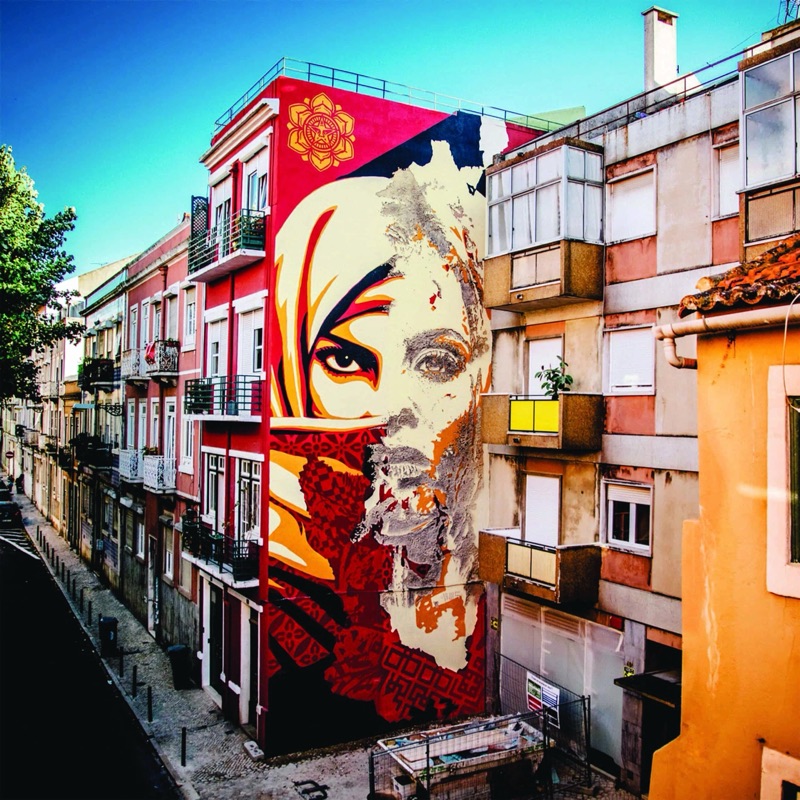 Shepard Fairey and Vhils collaborative mural in street context, Graça, Lisbon