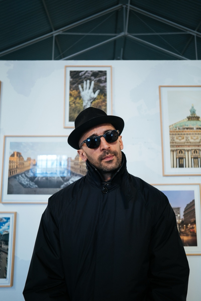 JR portrait in front of the salon hang, Underdogs Gallery, 2025